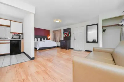 a large living room with a bed and a kitchen at Red Roof Inn PLUS+ & Suites Guilford in Guilford