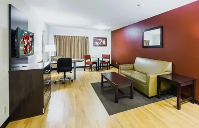 a living room with a couch and a table at Red Roof Inn PLUS+ South Deerfield - Amherst in South Deerfield