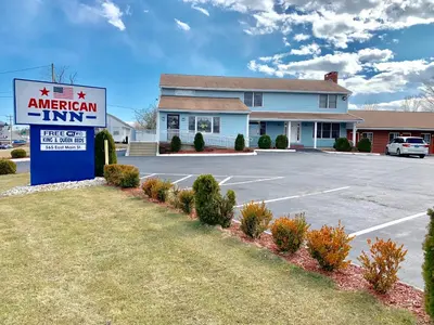 a american inn sign in front of a parking lot at American Inn in Branford