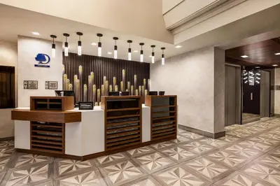 a lobby with a row of wine bottles at DoubleTree by Hilton New York Midtown Fifth Ave in New York