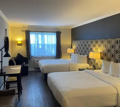a hotel room with two beds and a window at The Century House Latham - North Albany, an Ascend Collection Hotel in Latham