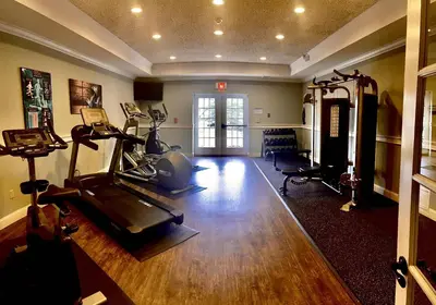 a gym with a treadmill and a exercise bike in a room at The Century House Latham - North Albany, an Ascend Collection Hotel in Latham
