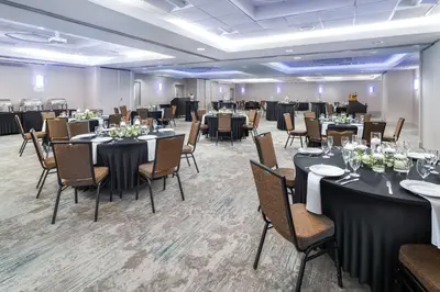 a ballroom with tables and chairs and a large room with tables and chairsktop at Hilton Garden Inn Rockaway in Rockaway