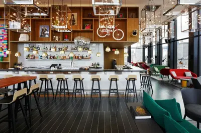 a bar in a restaurant with bar stools at citizenM New York Bowery in New York
