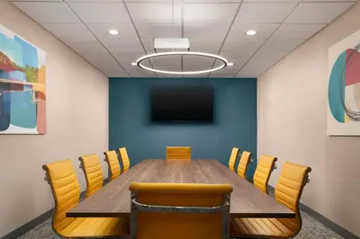 a conference room with a wooden table and yellow chairs at Hampton Inn Chicopee - Springfield in Chicopee