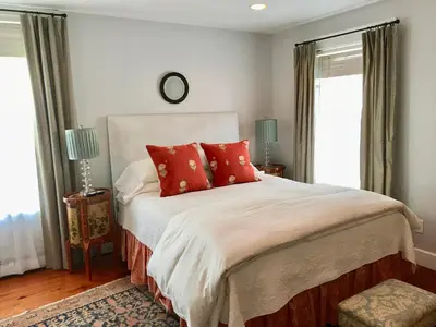 a bedroom with a large bed with red pillows at Hudson B&B in Hudson