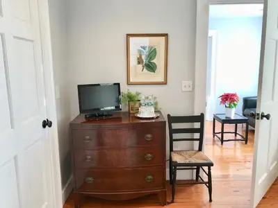 a living room with a television on a dresser at Hudson B&B in Hudson