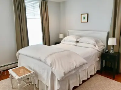 a bedroom with a large white bed with a window at Hudson B&B in Hudson