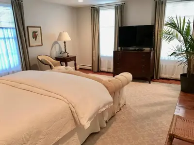 a bedroom with a bed and a flat screen tv at Hudson B&B in Hudson