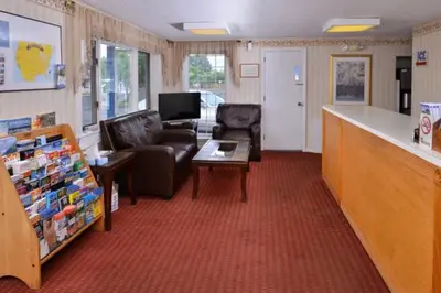 a waiting room with two leather chairs and a table at Best Stay Inn -Manchester in Manchester