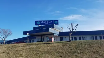 a building with two street signs on top of it at Best Stay Inn -Manchester in Manchester