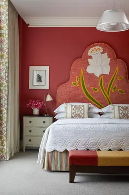 a bedroom with a red wall with a large bed at Crosby Street Hotel in New York