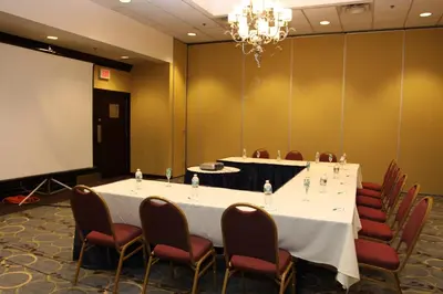 a meeting room with a long table and chairs at Holiday Inn Budd Lake - Rockaway Area by IHG in Budd Lake