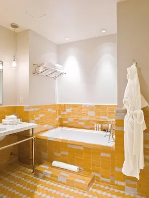 a large bathroom with a tub and a sink at The Greenwich Hotel in New York