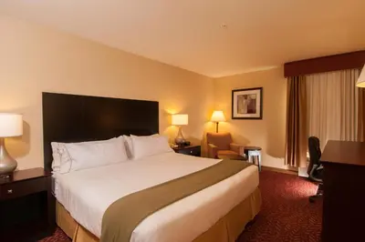 a hotel room with a large bed and a desk at Holiday Inn Express Vernon-Manchester by IHG in Vernon