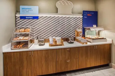 a bakery with a counter with donuts on it at Holiday Inn Express Vernon-Manchester by IHG in Vernon