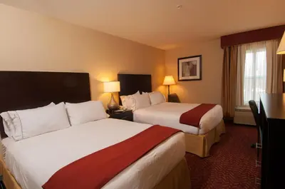 a hotel room with two beds and two lamps at Holiday Inn Express Vernon-Manchester by IHG in Vernon