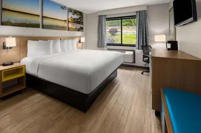 a hotel room with a large bed and a window at Days Inn by Wyndham Wurtsboro in Wurtsboro