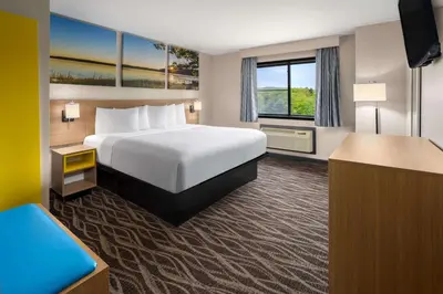 a hotel room with a bed and a window at Days Inn by Wyndham Wurtsboro in Wurtsboro
