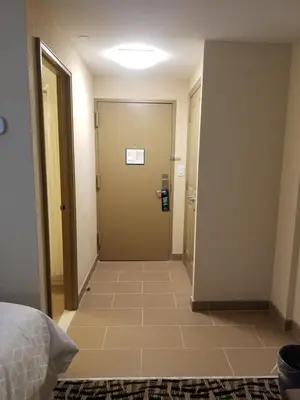 a hallway of a hotel room with a door at Holiday Inn Poughkeepsie by IHG in Poughkeepsie