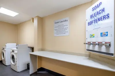 a laundry room with a washer and dryer at Holiday Inn Poughkeepsie by IHG in Poughkeepsie