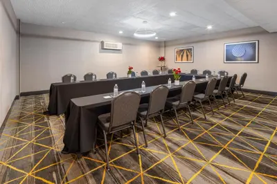 a conference room with a long table and chairs at Holiday Inn Poughkeepsie by IHG in Poughkeepsie
