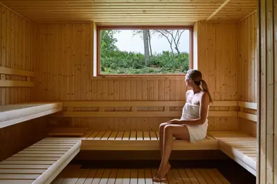 a woman sitting in a sauna at Troutbeck in Amenia