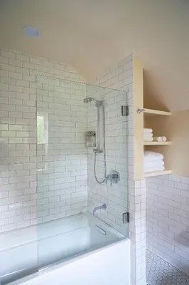 a bathroom with a tub and a glass shower at Troutbeck in Amenia