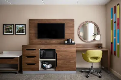 a room with a tv and a desk and a chair at Hampton Inn & Suites West Haven in West Haven