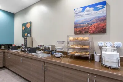 a bakery with a counter with pastries on it at Sleep Inn & Suites Monroe - Woodbury in Monroe