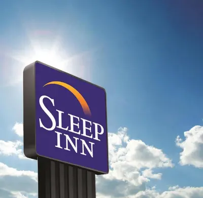 a sign for a sleep inn in front of a sky at Sleep Inn & Suites Monroe - Woodbury in Monroe