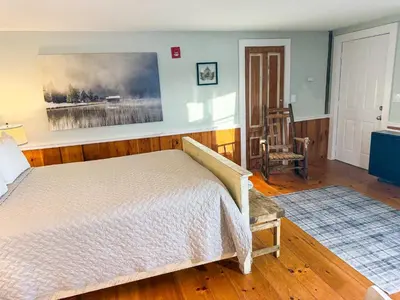 a bedroom with a bed and a painting on the wall at The Black Walnut Inn in Amherst