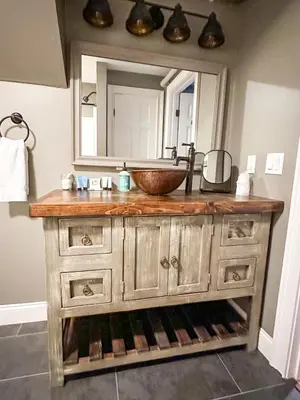 a bathroom with a wooden sink and a mirror at The Black Walnut Inn in Amherst