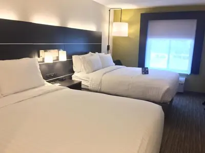 a hotel room with two beds and a window at Holiday Inn Express & Suites - Albany Airport - Wolf Road by IHG in Albany