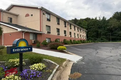 a hotel with a sign in front of a building at Days Inn by Wyndham Torrington in Torrington