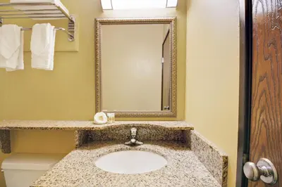 a bathroom with a sink and a mirror at Days Inn by Wyndham Torrington in Torrington