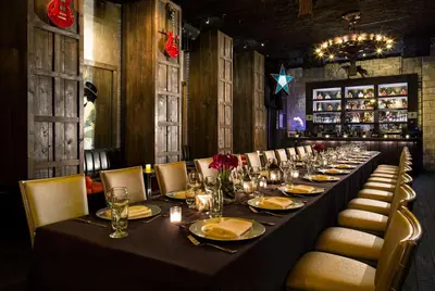 a long table in a restaurant with chairs and a table set for dinner at Dream Downtown, by Hyatt in New York