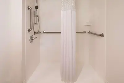 a shower with a shower curtain in a bathroom at Hampton Inn White Plains/Tarrytown in Elmsford
