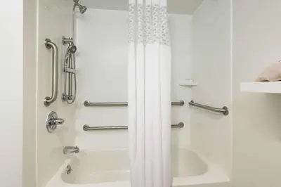 a bathroom with a shower and a bath tub at Hampton Inn White Plains/Tarrytown in Elmsford