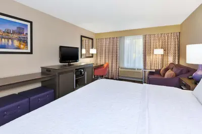 a hotel room with a bed and a television at Hampton Inn Waterbury in Waterbury