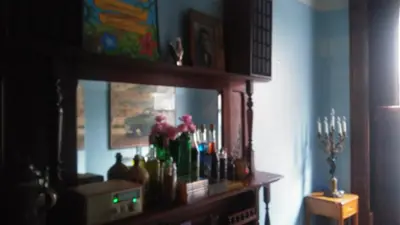 a room with a shelf with bottles and candles at The Harlem Flophouse in New York