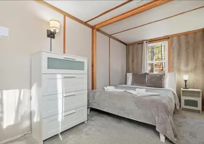 a bedroom with a bed and a dresser with a tv at Pocono cabin with hot tub and private pool at Shawnee Mtn in East Stroudsburg