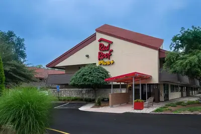 a restaurant with a red roof and a sign on it at Red Roof Inn PLUS+ West Springfield in Springfield