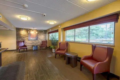 a waiting room at a hospital with chairs and a table at Red Roof Inn PLUS+ West Springfield in Springfield