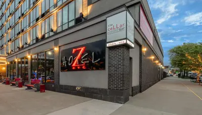 a store with a sign on the side of a building at Z NYC Hotel in Queens