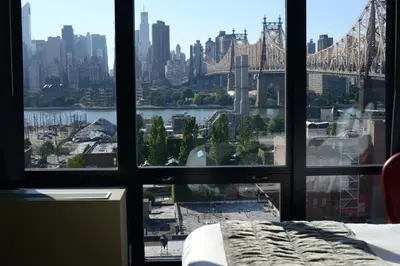 a view of the brooklyn bridge from a bedroom window at Z NYC Hotel in Queens