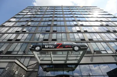 a car on the side of a tall building at Z NYC Hotel in Queens