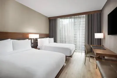 a hotel room with two beds and a desk at AC Hotel by Marriott New York Downtown in New York