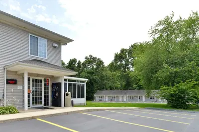 a parking lot in front of a building at Tower Inn and Suites of Guilford / Madison in Guilford