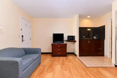 a living room with a couch and a tv at Tower Inn and Suites of Guilford / Madison in Guilford